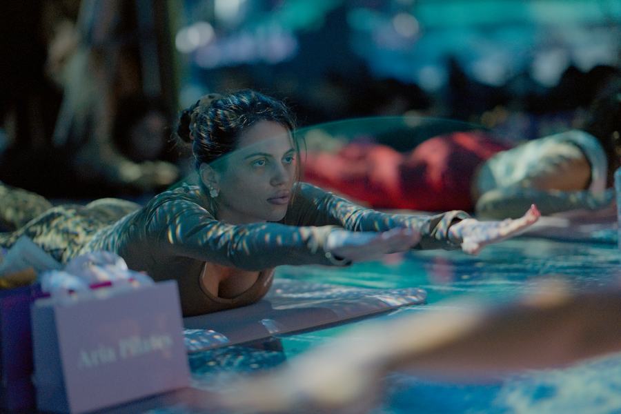 Guest reaching forward in a stretch beside her ARIA gift bag